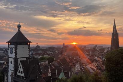 Sunset in Freiburg, the Munster and Schwabentor are visible
