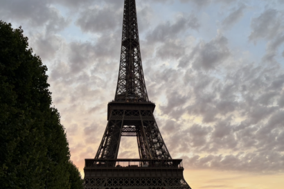A silhouette of the Eiffel Tower in front of an orange sunset