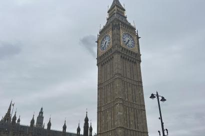 The bell tower at the Houses of Parliament set against gray skies.