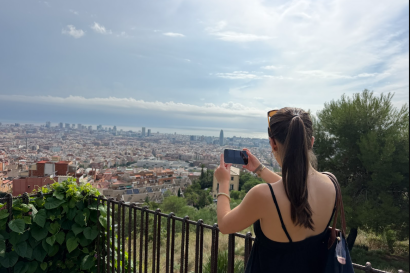 Girl taking picture of view of Barcelona from Bunkers del Carmel