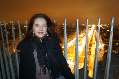 Three people standing in front of ancient ruins with arches, sunny day. This alt text was added with Al; accuracy may vary.