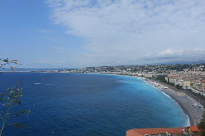 White candle and "Anna Karenina" book on a cozy table setting. This alt text was added with Al; accuracy may vary.