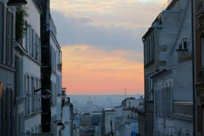 1. Archway view of distant cityscape under blue sky.
2. Ferris wheel silhouette at sunset, city skyline.
3. Narrow street at sunset with pastel sky. This alt text was added with Al; accuracy may vary.