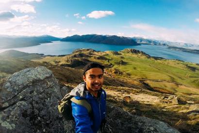 1. Historic cathedral with spire, surrounded by green trees.
2. Interior of cathedral with tall stone arches.
3. Cathedral interior, stained glass windows.
4. Park with crowd sitting on grass, scattered trees.
5. Person in blue jacket on mountain with lake view. This alt text was added with Al; accuracy may vary.