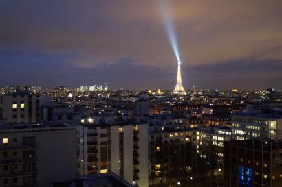 Cityscape with the Eiffel Tower illuminated at night. This alt text was added with Al; accuracy may vary.