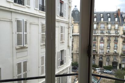 Cup raised in a Paris street café setting. This alt text was added with Al; accuracy may vary.