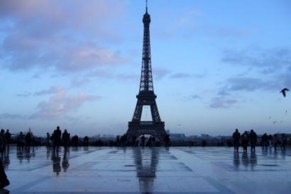 Crowd gathered in a park under sunlit trees.

Performer in traditional costume under trees, crowd watching.

Eiffel Tower against a blue sky, silhouetted by evening light. This alt text was added with Al; accuracy may vary.