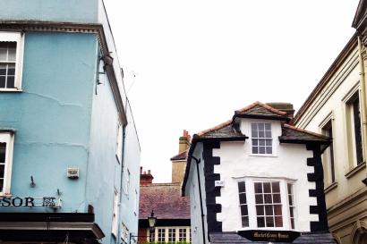 Narrow street with colorful buildings and small shops. 