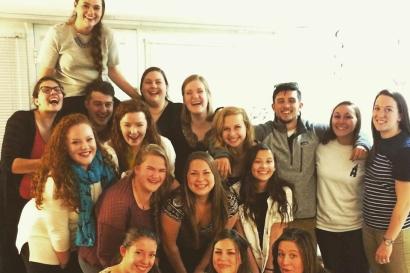 Smiling person in a striped shirt indoors. This alt text was added with Al; accuracy may vary.