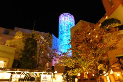 1. Basketball court with players and spectators under warm lights.
2. Scoreboard shows tied score, 36-36, with 2.27 remaining.
3. Group of people walking down a narrow, bright corridor.
4. Vibrantly lit cylindrical tower in a courtyard at night. This alt text was added with Al; accuracy may vary.