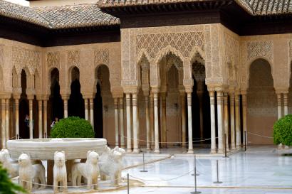 Courtyard with intricate arches and lion fountain, Alhambra, Spain. This alt text was added with Al; accuracy may vary.