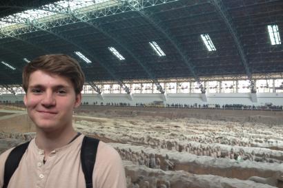 Musicians playing guitars outdoors, surrounded by people. This alt text was added with Al; accuracy may vary.