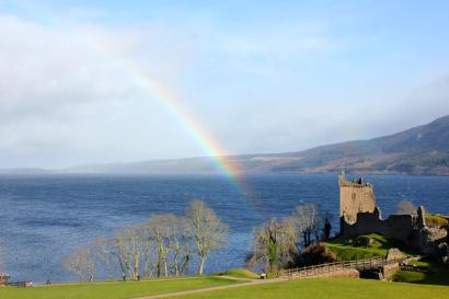 Rainbow over Loch Ness with a castle on the right. This alt text was added with Al; accuracy may vary.