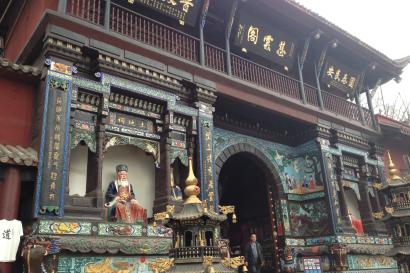 Ornate Chinese temple facade with colorful carvings and statues. This alt text was added with Al; accuracy may vary.