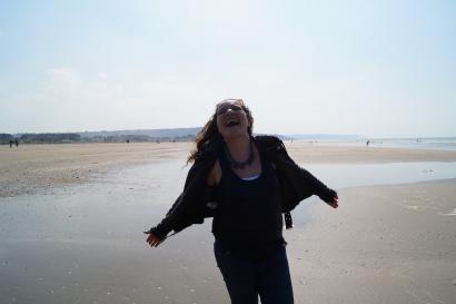 1. Pink bicycle by a canal with historic buildings.
2. Rooftop view of a European city with mixed architecture.
3. Person joyfully walking on a sandy beach, arms outstretched. This alt text was added with Al; accuracy may vary.