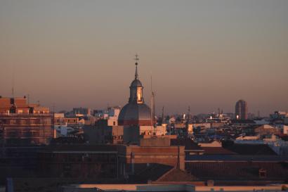 City skyline at sunset with a domed building in the center. This alt text was added with Al; accuracy may vary.