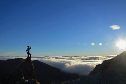 1. Cityscape with red roofs, green hills, and cloudy sky.
2. Graffiti-covered wall with colorful artwork.
3. Snowy mountain landscape under a sunny sky.
4. Person standing on mountain peak above clouds against the sun. This alt text was added with Al; accuracy may vary.