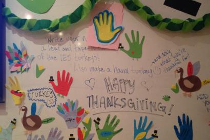 Paella with shrimp and lemon slices in a large pan. This alt text was added with Al; accuracy may vary.