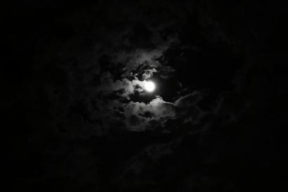 River winding through grassy hills under a cloudy sky.

Moon partially obscured by dark clouds in the night sky. This alt text was added with Al; accuracy may vary.