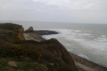 Breakfast bowls with fruit, coffee, and pastries on a wooden table.

Pillared balcony overlooking countryside with blue sky.

Cliffs overlooking a cloudy ocean view at the beach. This alt text was added with Al; accuracy may vary.