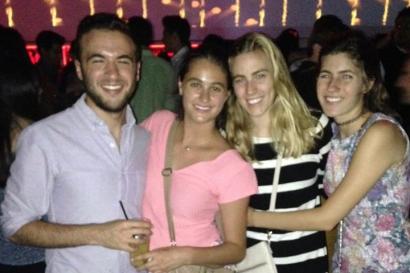 Dog standing on a quiet street.

Red tank top with a colorful Galapagos design.

Four friends smiling at a party. This alt text was added with Al; accuracy may vary.