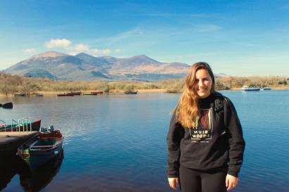 Silhouette of person with arms outstretched on a rocky beach at sunset. This alt text was added with Al; accuracy may vary.