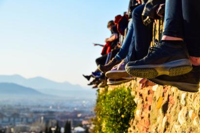 Blurred incense smoke rises before a traditional temple facade. This alt text was added with Al; accuracy may vary.