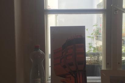 1. Person gazing at a lake from a leafy viewpoint.
2. Swan in water with a city skyline in the background.
3. Narrow street with colorful buildings under an archway.
4. Cliffs meeting the ocean under a cloudy sky.
5. Window sill with a water bottle and framed art. This alt text was added with Al; accuracy may vary.