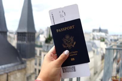 My passport in front of Parisian apartments