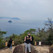 Author, Macks, posing at the top of a mountain at Itsukushima Shrine.