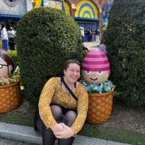 Author, Macks, sitting next to a small statue of Edith from Despicable Me.