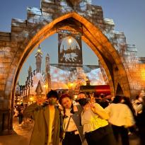Author, Macks, and his friends standing in front of the Harry Potter attraction in Universal Studios, Japan.