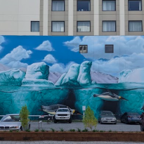 Mural of penguins sitting on chunks of floating ice and diving into the water