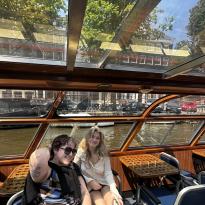 Two people in a boat in the Amsterdam canal