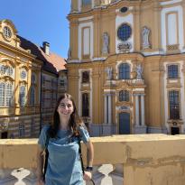 Girl smiling at camera in front of the Abbey at Melk