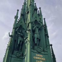 This image shows the green monument on the top of Viktoriapark. The monument is reminiscent of the main steeple on a gothic cathedral
