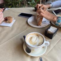 Cappuccinos and different pastries from a cafe in Siena 