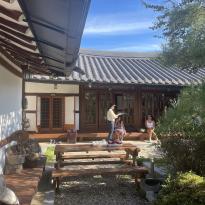 Image of hanok, traditional Korean home, with students in background 