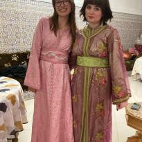 Two young people dressed in colorful formal Moroccan caftans
