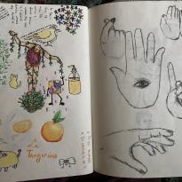 A two-page journal spread with pen and colored pencil drawings. On the right are song lyrics about birds, drawings of floral patterns, a tangerine, a woman covered in vines, a pokémon, a juice, and a bird. On the right are drawings of realistic hands in black colored pencil.
