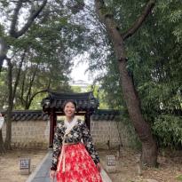 Author wearing black and red hanbok