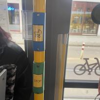 Two buttons on a pole, one with a stroller on it and the other reading "stop"