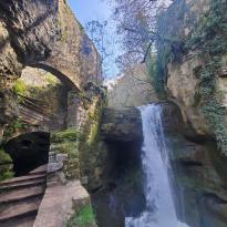 A stunning waterfall drop next to the ruins of a mill.