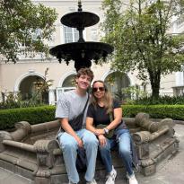 My host mother and I sitting on the ledge of a fountain in the middle of a garden in Quito.