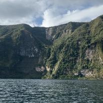A mountainous landscape with a lake in front. Taken from the sightline of the water.