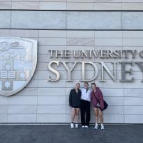 Posing in front of the University of Sydney sign