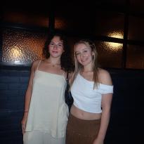 Two friends pose outside of a restaurant in Brisbane 