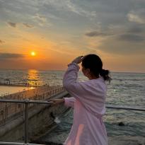a person looking towards the sunset 