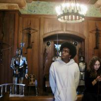 Person standing around medieval armor