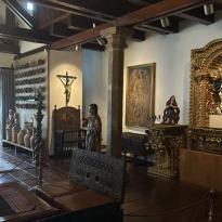 interior Guayasamín Museum; dark wooden statues and religious art